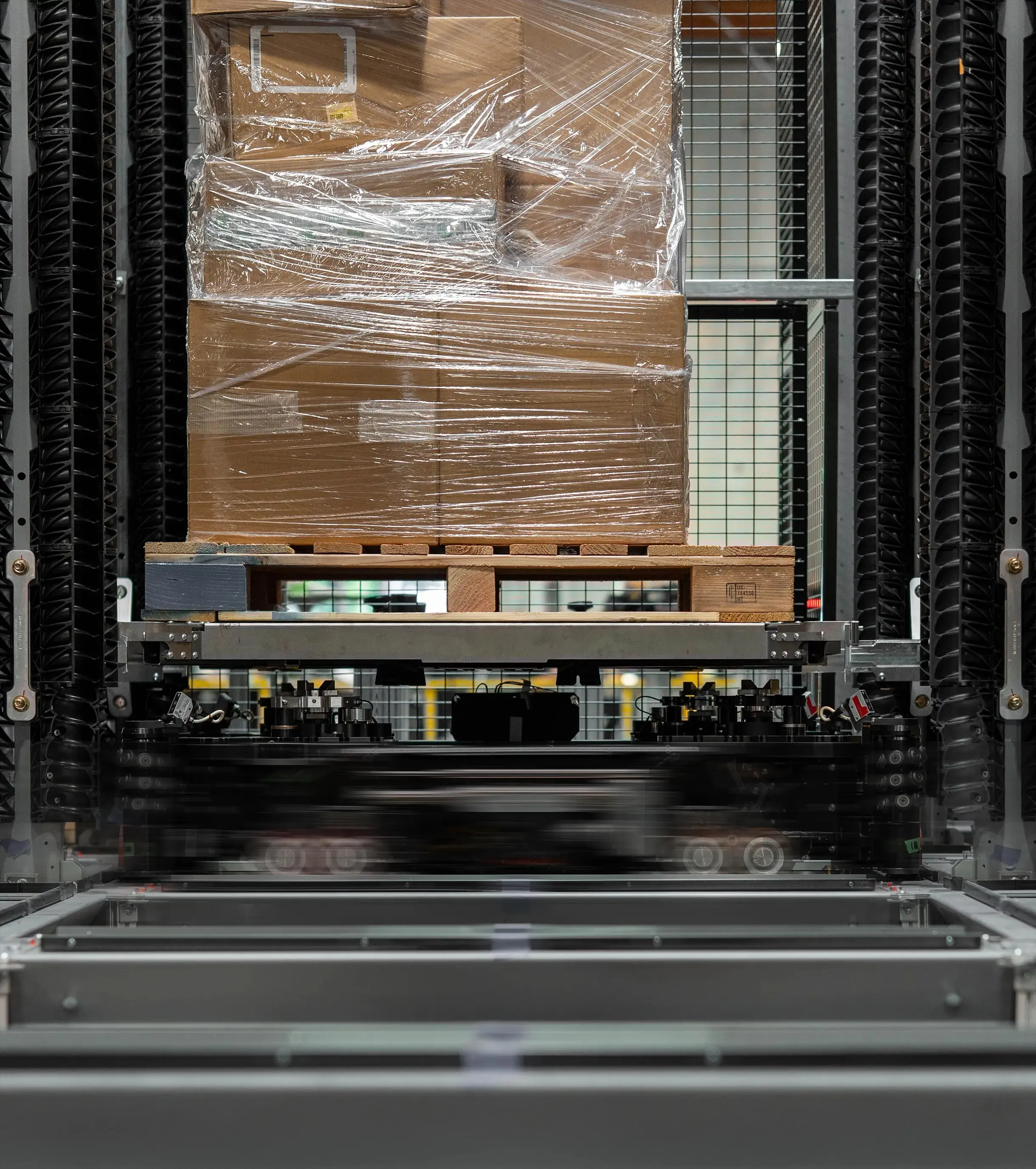 Plastic-wrapped pallet of cardboard boxes in industrial press