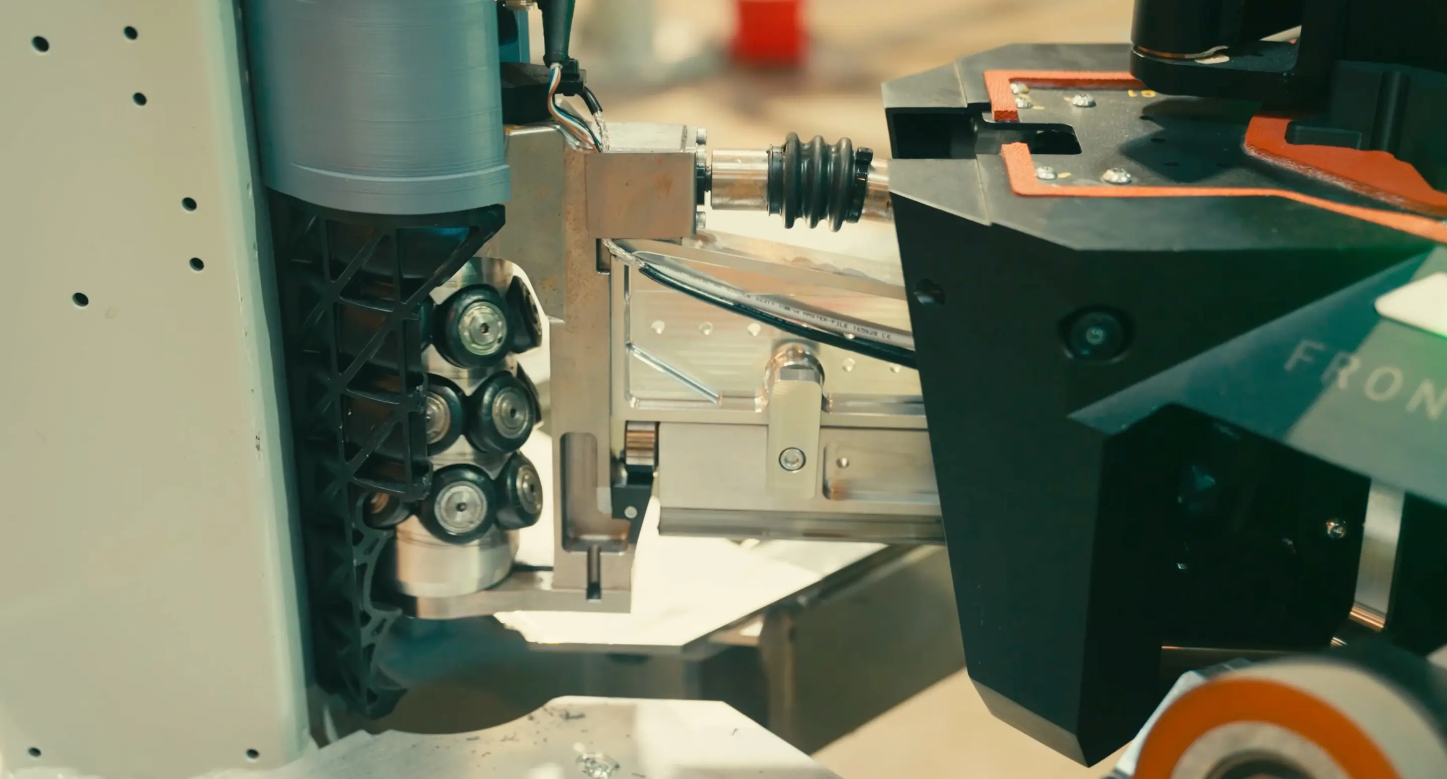 Industrial machinery with gears and mechanical components mounted on perforated panel.