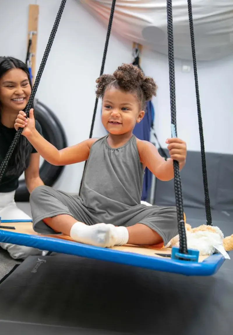Swing work, therapist at her side